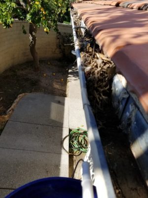 gutter cleaning before and after photo on home in Yucaipa, California